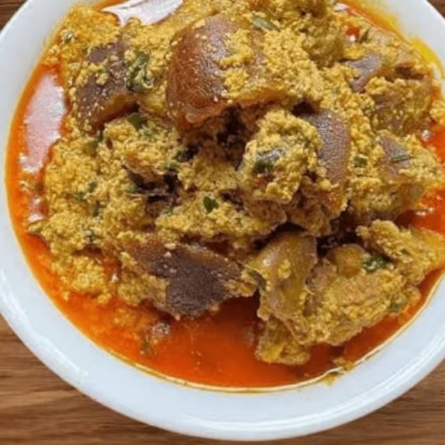 Egusi Soup with Pounded Yam, Garri, White Yam, or White Rice.