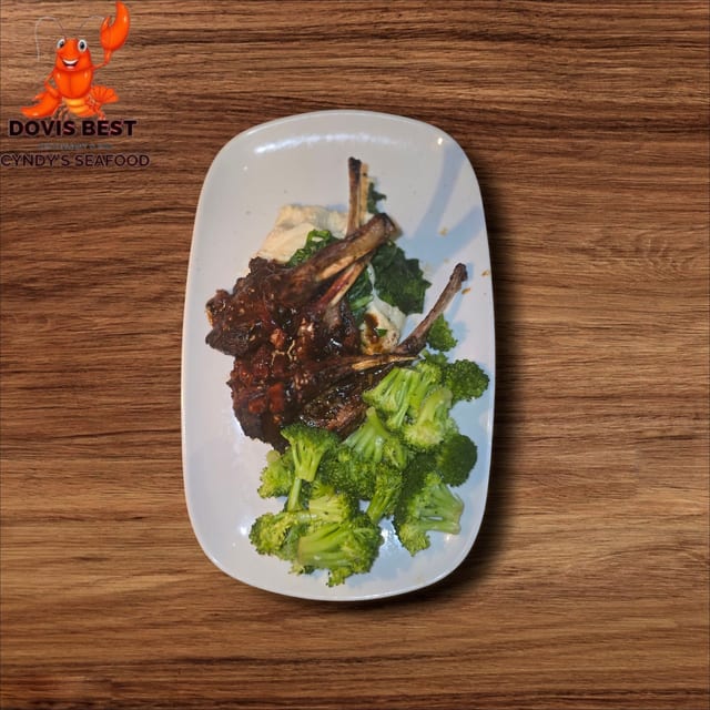 Grilled Lamb Chop with Jollof Rice and Sauteed Broccoli or Asparagus or Collard Green or Spinach.