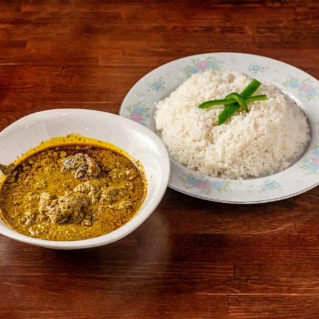 Peanut Soup with White Rice, Boiled Plantains, or White Yams.