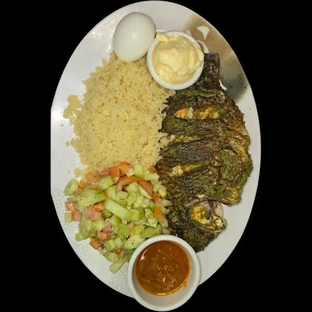Attieke with Grilled Tilapia, Mixed Vegetables With Sauce.