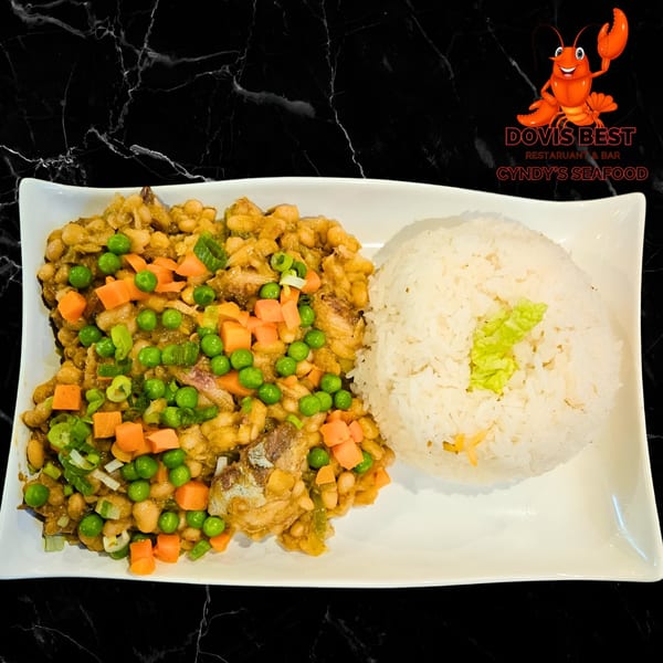 A plate of seafood stew with peas, carrots, and white rice from Cyndy's Seafood.